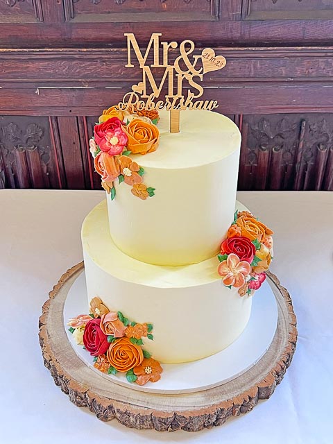 Modern two tier wedding cake with colourful sugar flowers at Rothamsted Manor
