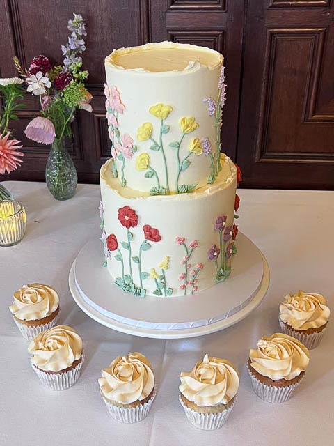 Two tier buttercream wedding cake with hand piped floral details at Rothamsted Manor Harpenden