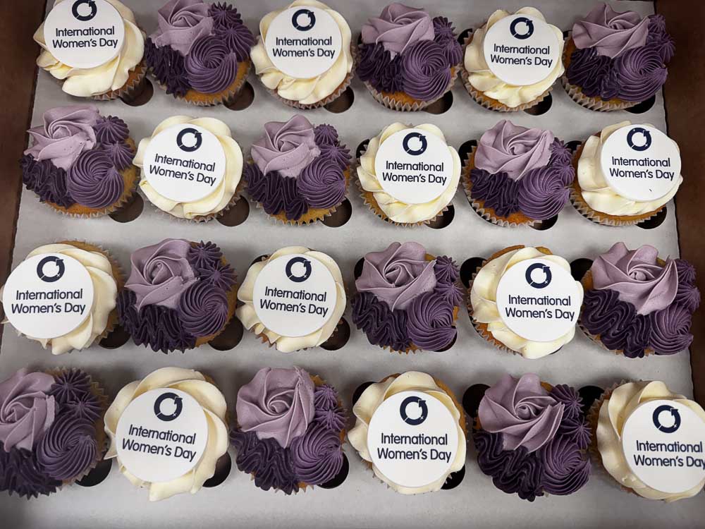 Purple and white branded cupcakes created for CPW's International Women's Day event in Welwyn Garden City